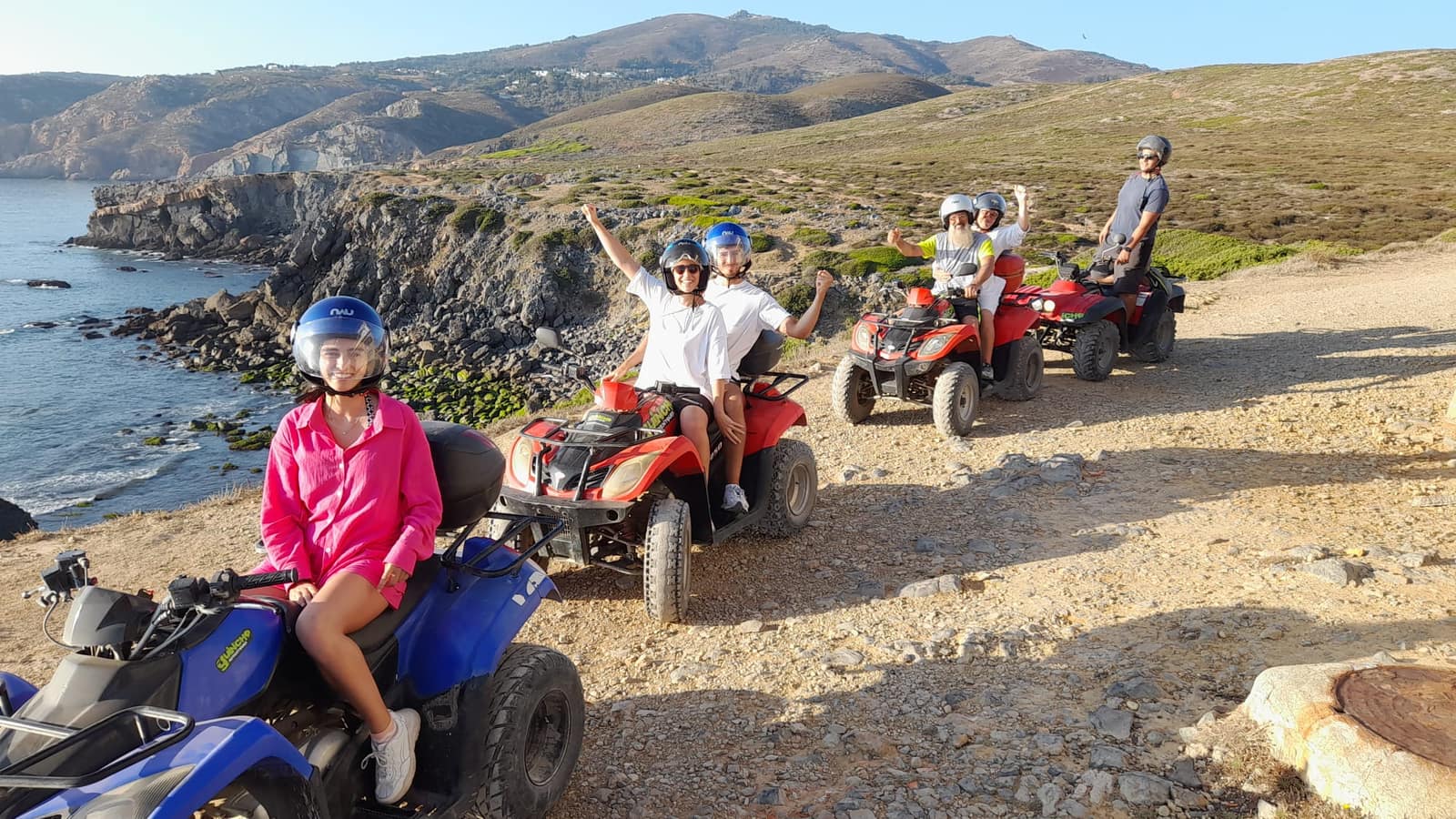 Small group of riders stopped at a coastal viewpoint on the Guincho trail